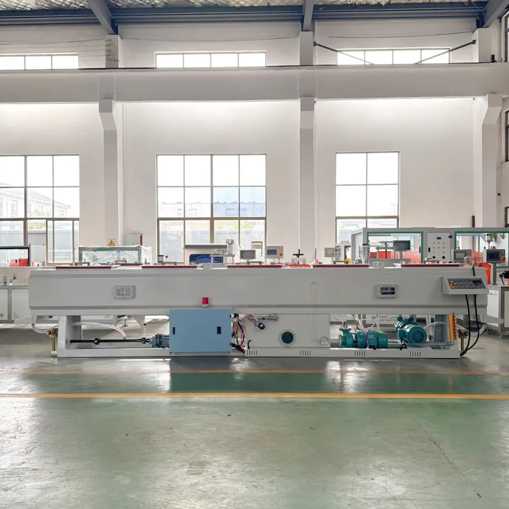 A long white 315 PVC vacuum calibration tank with a control panel stands in a bright factory workshop