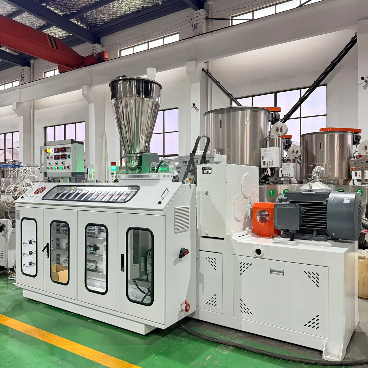 PVC pipe extrusion line driven by a conical twin screw extruder