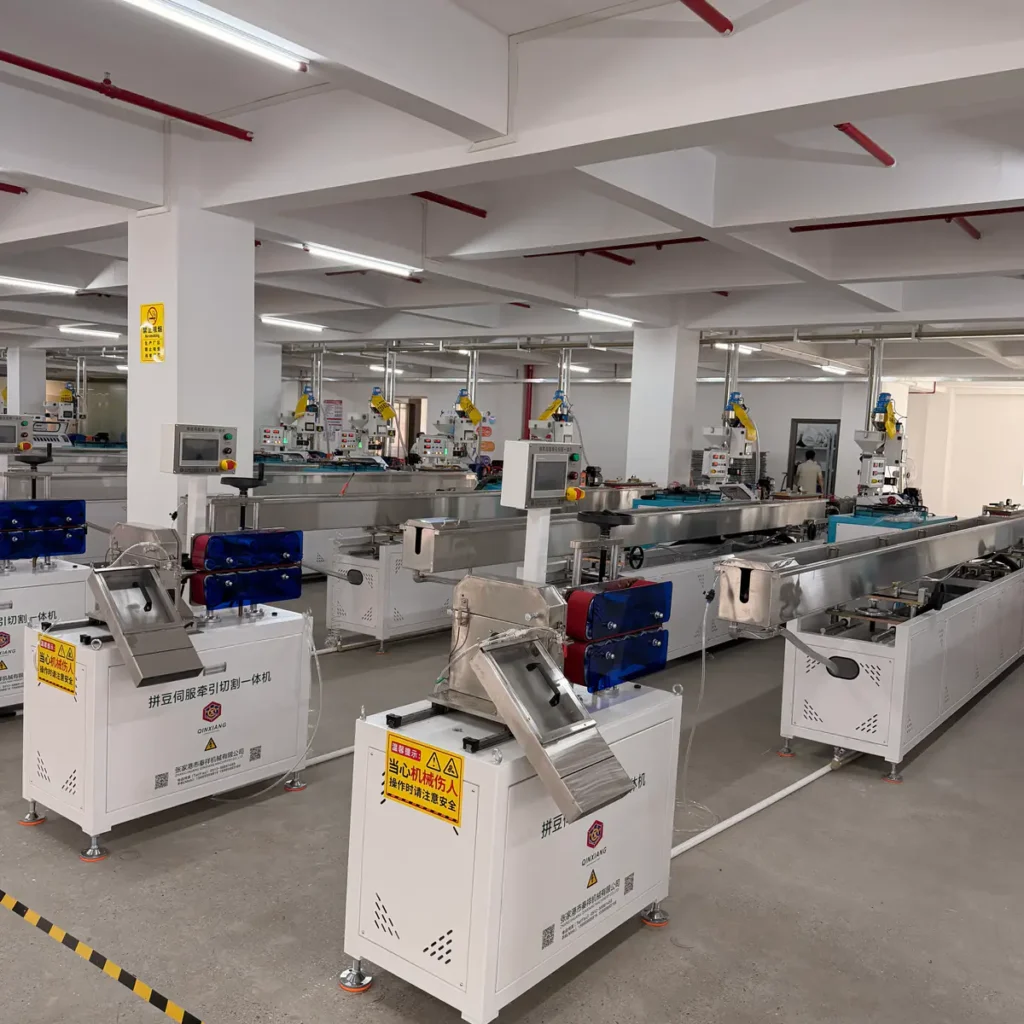 Several haul-off and cutter integrated machines installed in a spacious factory workshop with multiple extrusion lines