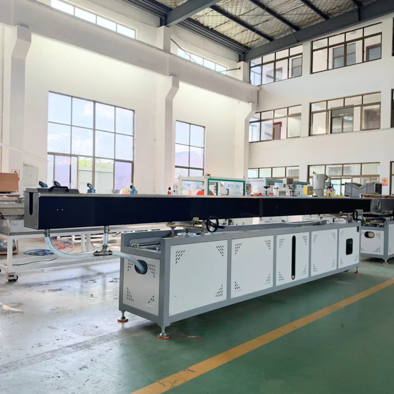 A long white and black industrial water cooling tank is installed in a spacious factory workshop with large windows and green