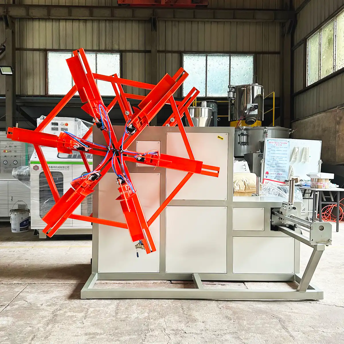 Automatic unloading arm removing a heavy pipe coil from the coiler onto a conveyor