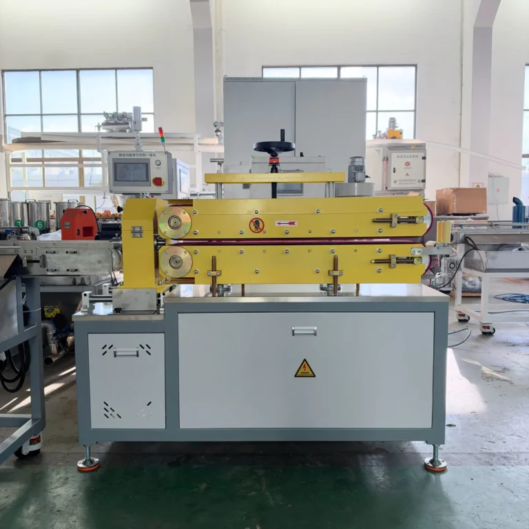 Yellow haul-off cutter with control panel installed in a factory workshop among other extrusion equipment