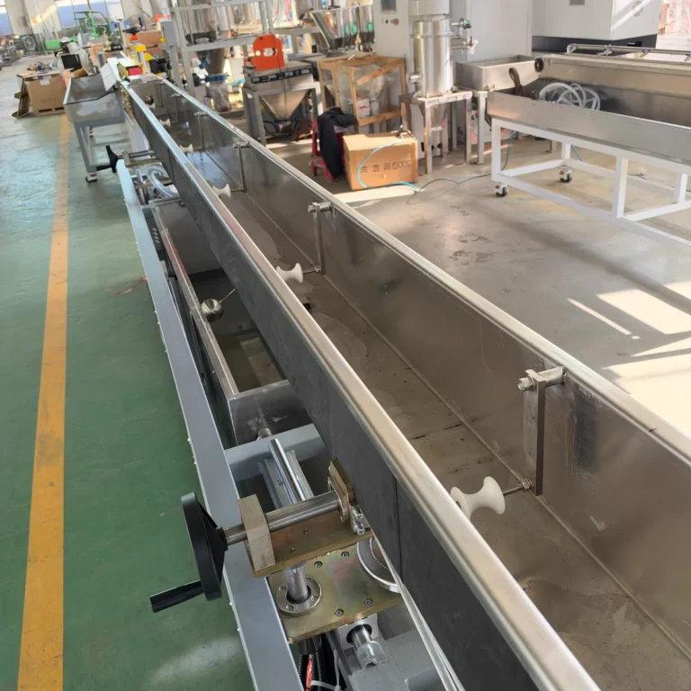 Stainless steel water cooling tank with blow drying device installed in a factory workshop surrounded by other extrusion