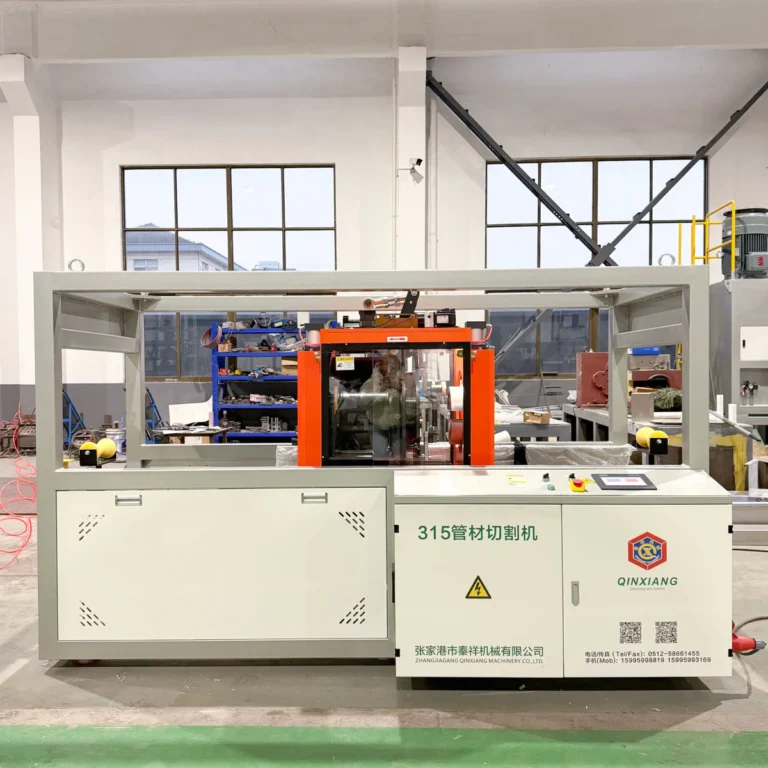 Pipe cutting machine with safety enclosure and control panel in a factory workshop, shelving and equipment visible
