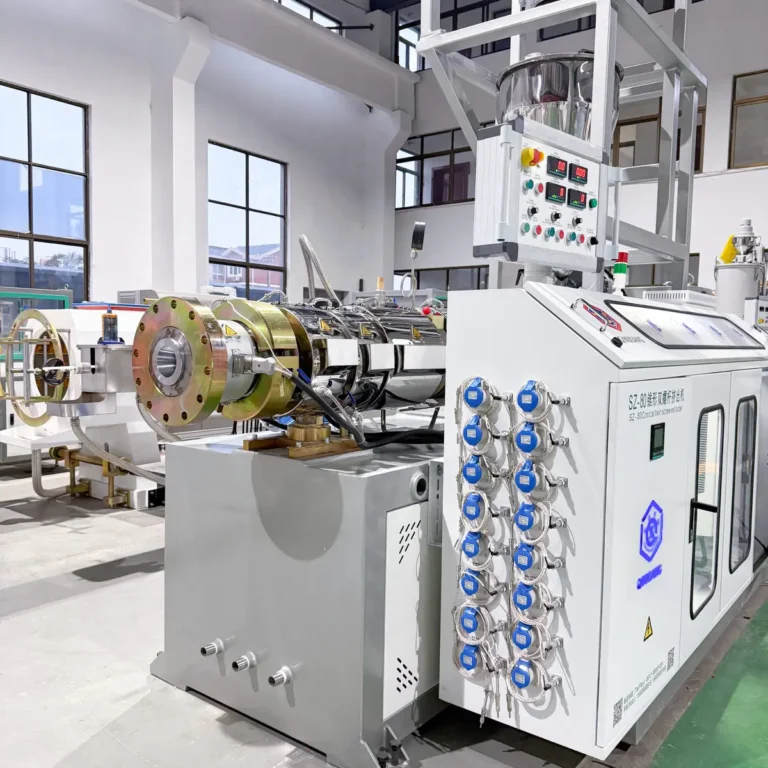 PVC pipe extrusion line main extruder with control cabinet and feeder installed in a factory workshop with large windows