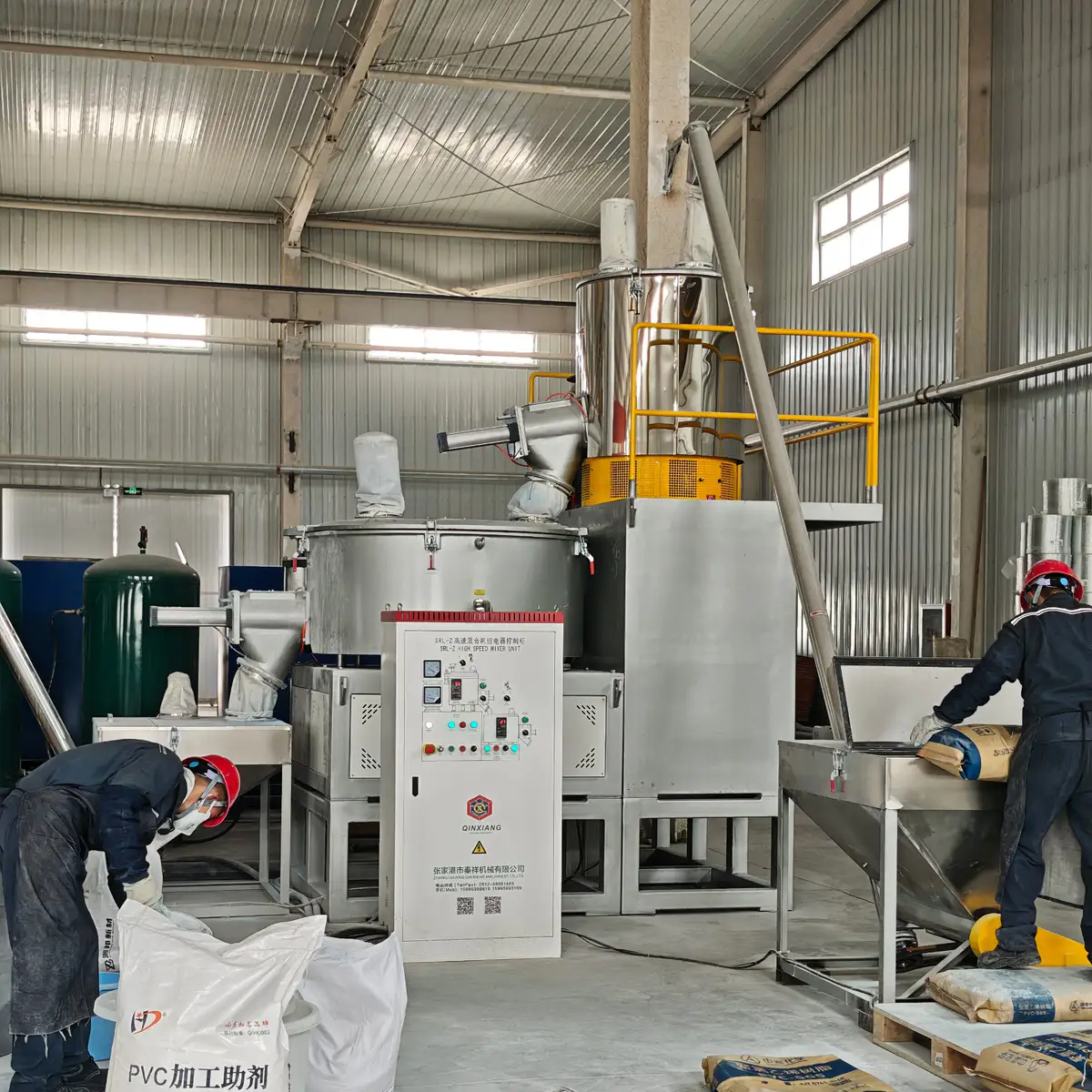 PVC dry blend powder and calcium carbonate in a mixing and feeding station for a PVC pipe line